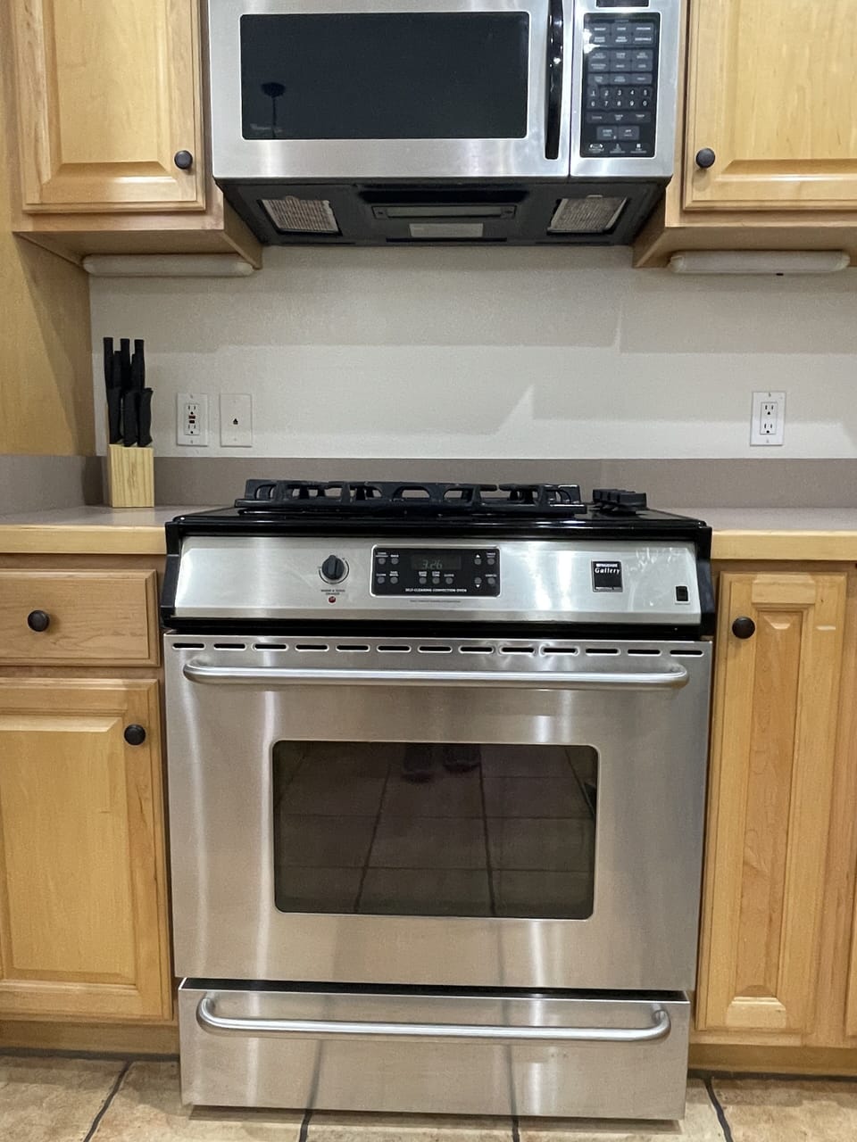 Gas range with microwave/vent hood.