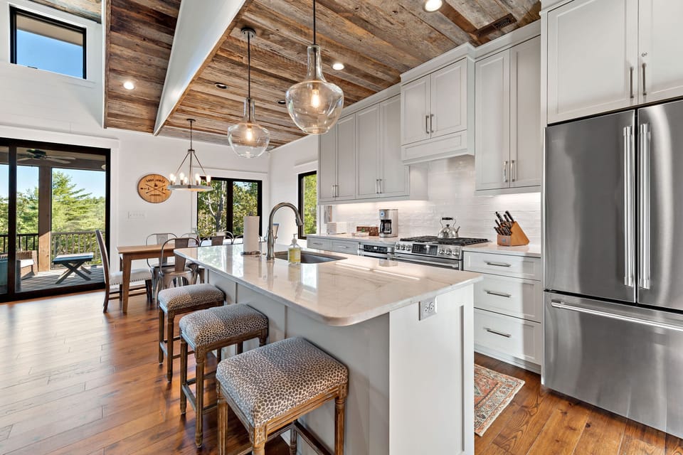 A modern kitchen equipped with stainless steel appliances, quartz countertops ideal for preparing meals.