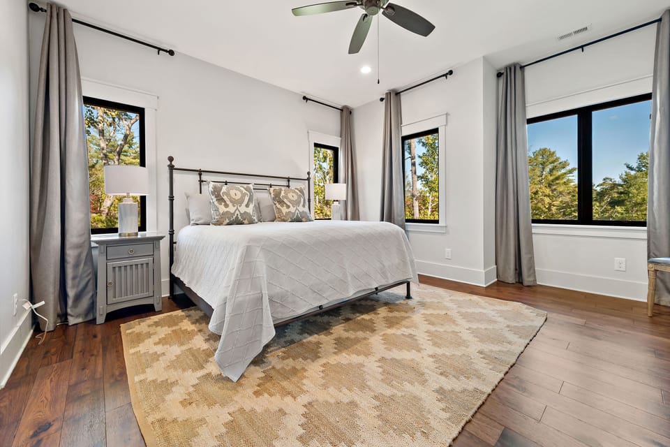 Opulent primary bedroom featuring a King-sized bed and en suite bathroom with a walk-in shower.