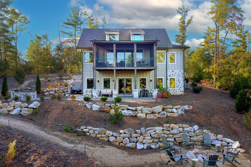 A stunning exterior shot showcasing the lodge's modern architecture, nestled atop a hill with panoramic views of Lake James.