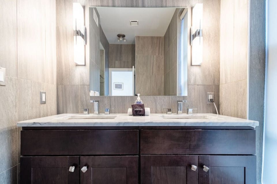Modern bathroom with updated tile work and sleek vanity.
