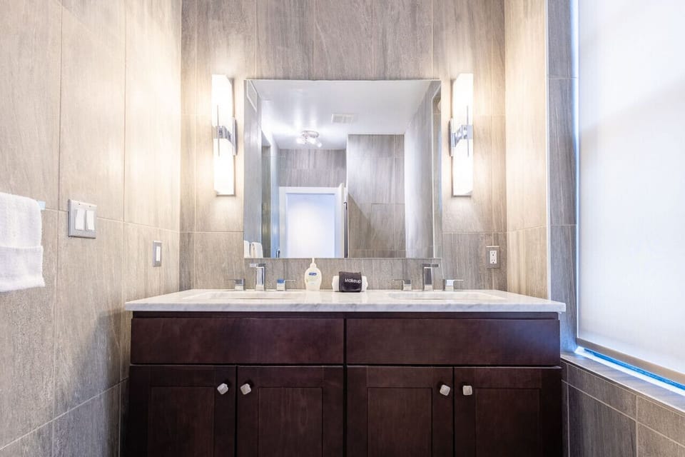 Bathroom detail showing rainfall shower and premium fixtures