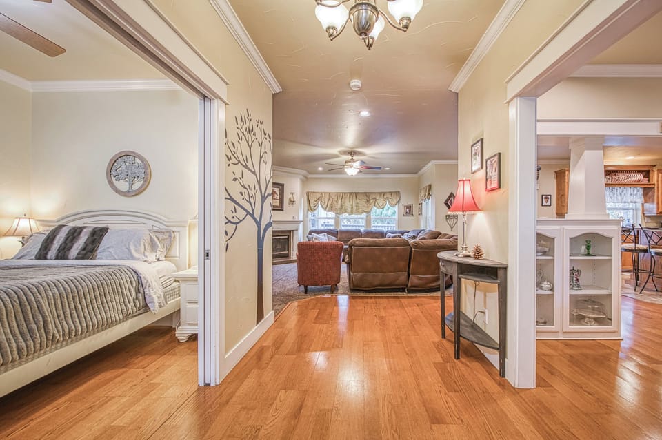 view standing in front of front door.  Dining room on right, queen room on left
