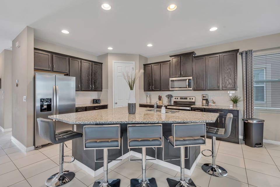 Well stocked, beautiful kitchen, with five island stools.