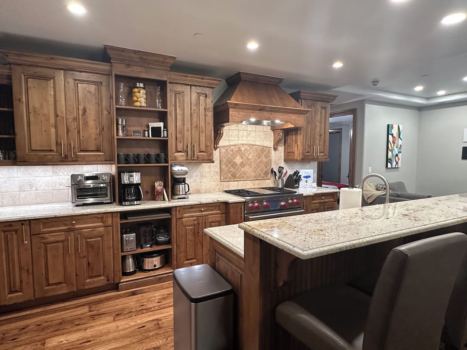 Open kitchen featuring Wolf appliances and a Sub-Zero fridge.