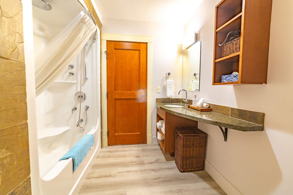A luxurious bathroom include a soaker tub and jet massage shower 