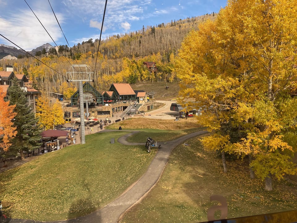 Autumn view as gondola approaches mountain village core
