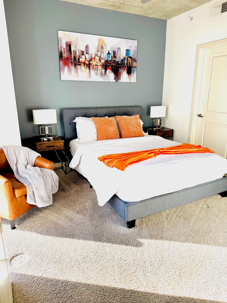 Queen size bed with a chair to relax