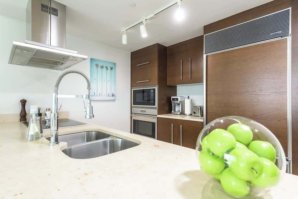 "Cook and gather in this sleek Airbnb kitchen with stainless steel appliances, modern design, and fresh touches — your vacation rental comfort zone."


