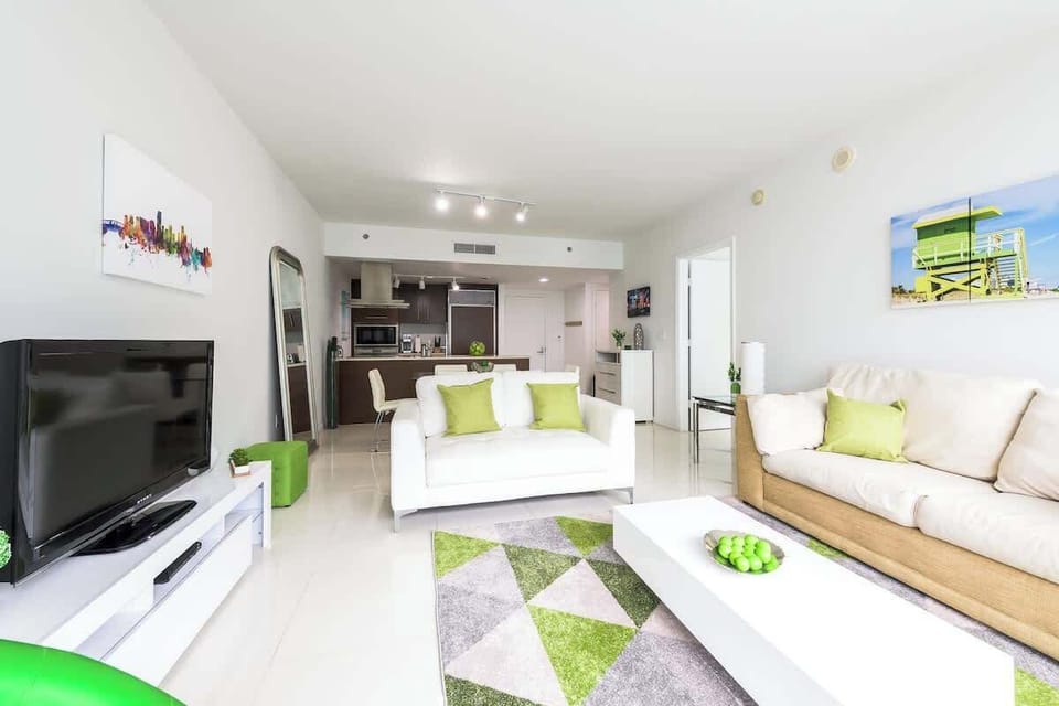 "Enjoy open living in this stylish Airbnb apartment with modern kitchen, cozy sofas, and vibrant décor — perfect for your vacation rental stay."

