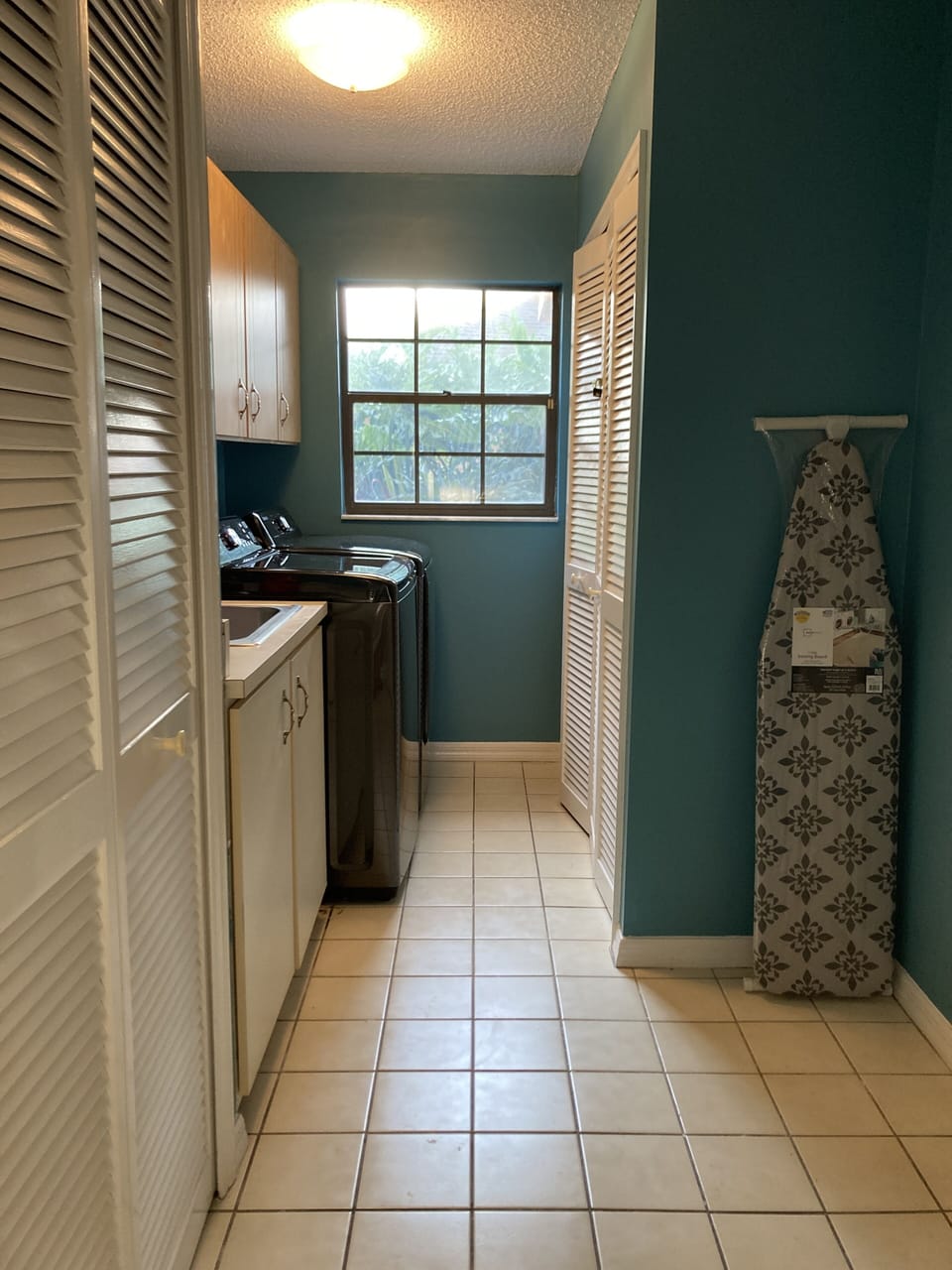 Laundry room with new Samsung washer, dryer, iron & iron board