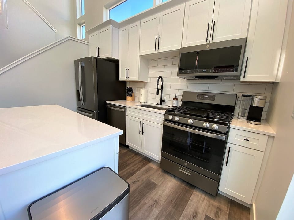 Full sized stainless steel appliances including a gas stove