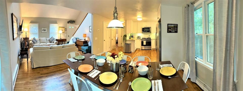 Panoramic view of dining room, living room, and kitchen