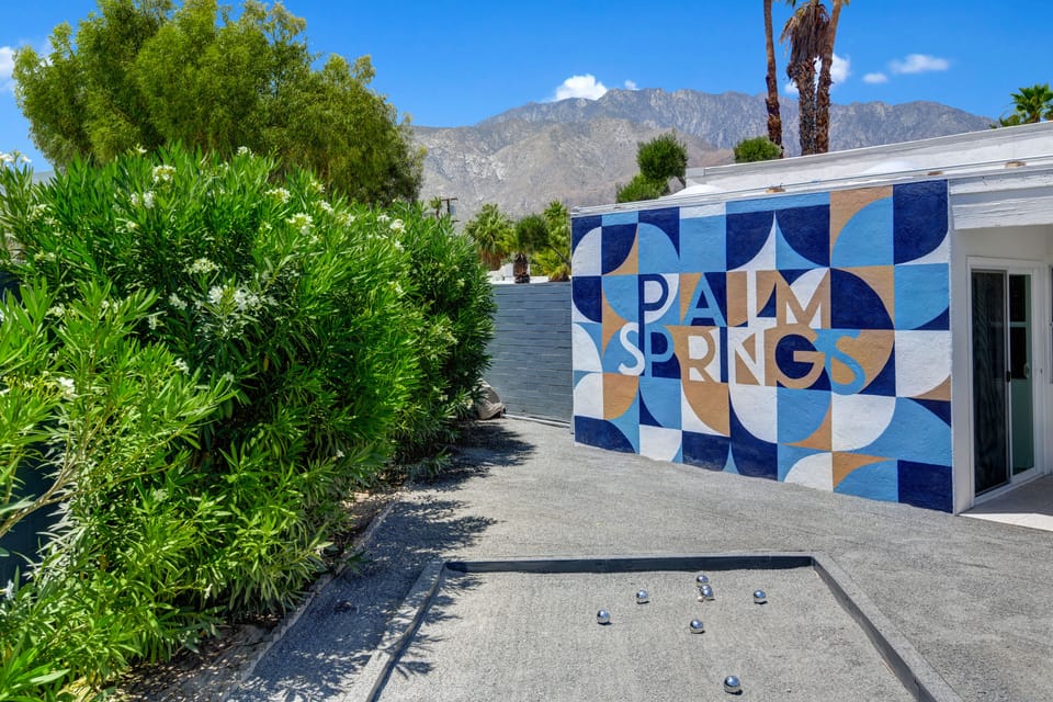 Take a photo in front of the custom mural wall.