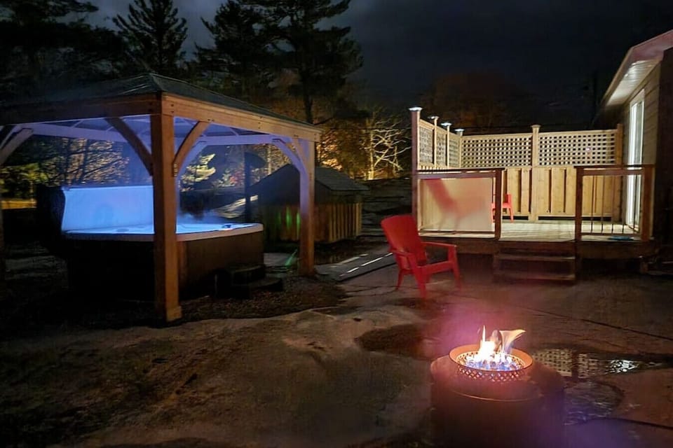 Backyard area with fire pit and hot tub and patio off master bedroom