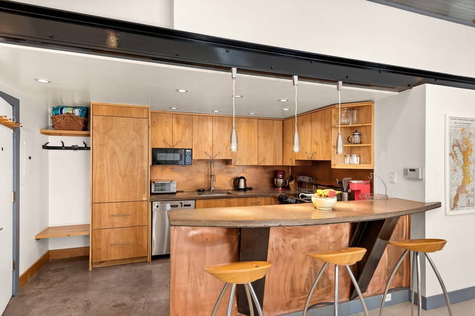 You will appreciate the fully stocked kitchen with custom cabinets and copper finishes when staying at this convenient studio loft condo in Aspen.