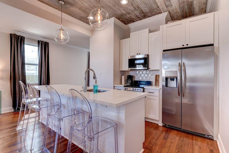 Sleek kitchen w/ bar seating — perfect for morning coffee or casual meals.
