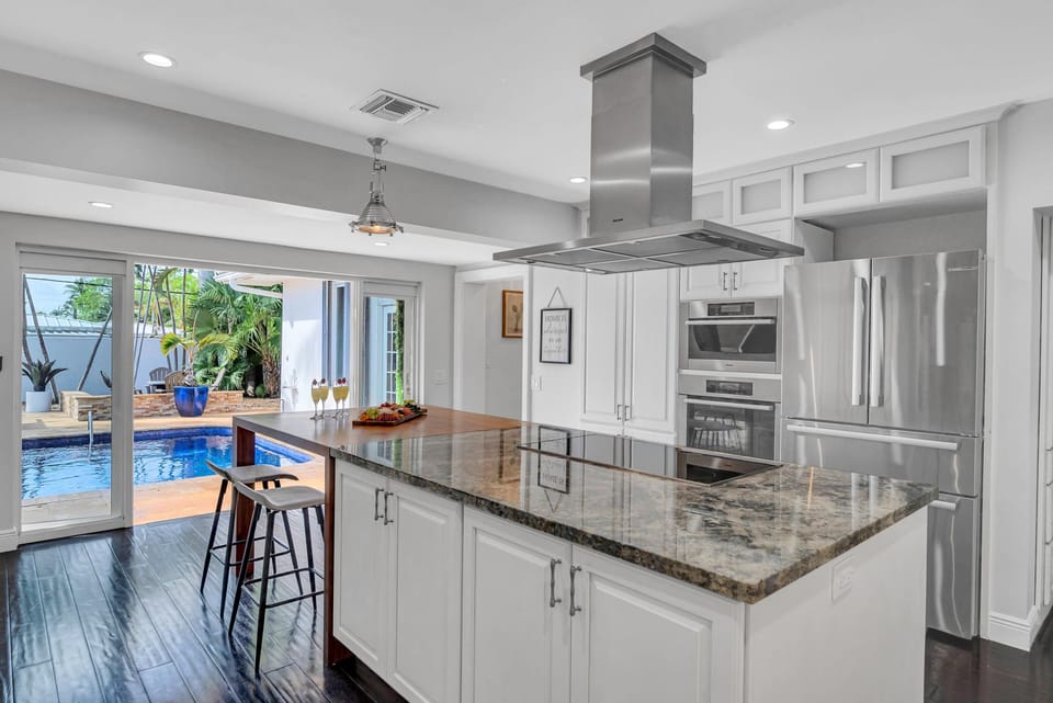 The Chef's Kitchen with its own seating for casual meals and access to the heated pool.