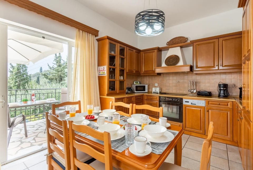 Open-plan living room with sofas, dining area, kitchen, A/C, WiFi internet, satellite TV, and terrace access with sea views