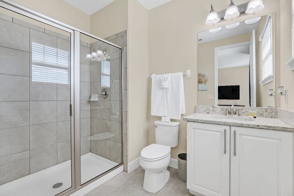 A modern walk-in shower and spacious double vanity give everyone room to get ready with ease and comfort.