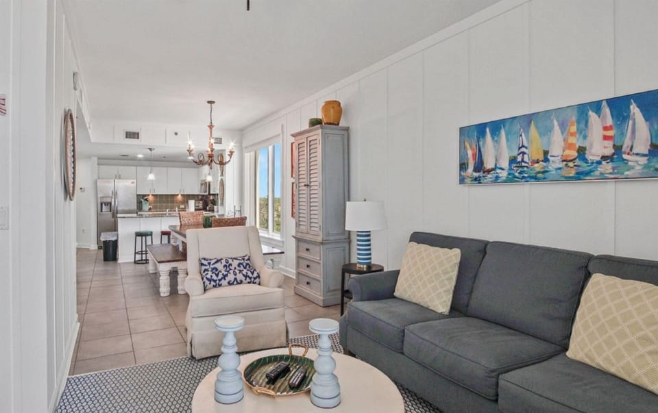 Relax in your coastal-themed living space with comfortable seating and artwork that brings seaside charm to your home away from home.