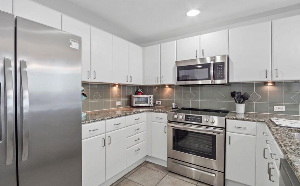 Your fully equipped kitchen awaits with granite counters, stainless appliances, and warm under-cabinet lighting for memorable meal prep.
