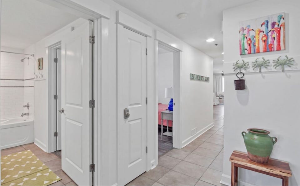 Step into your bright, airy hallway where thoughtful touches like coastal artwork and charming décor create a welcoming home-away-from-home atmosphere.