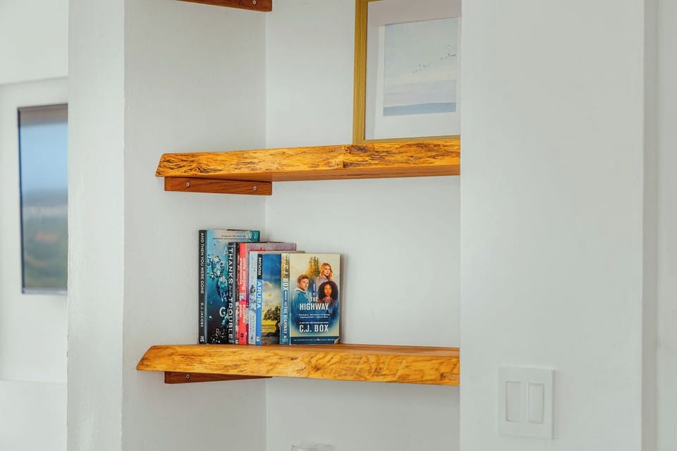Bright open-concept living space with stunning hillside views, perfect for relaxing after beach days and island adventures