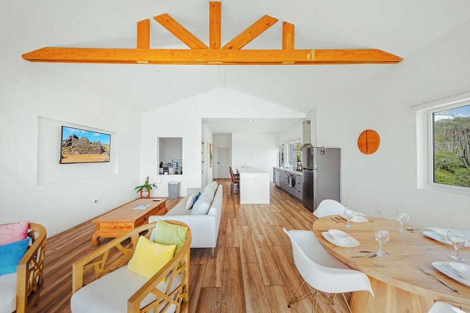 Bright open-concept living space with stunning hillside views, perfect for relaxing after beach days and island adventures
