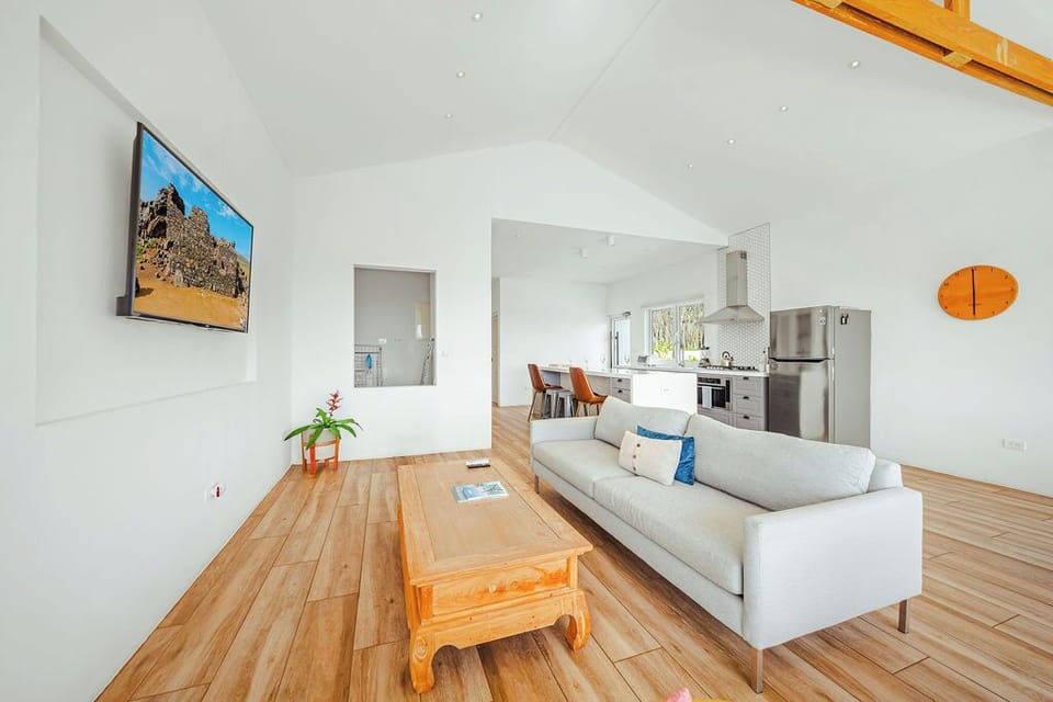 Bright open-concept living space with stunning hillside views, perfect for relaxing after beach days and island adventures