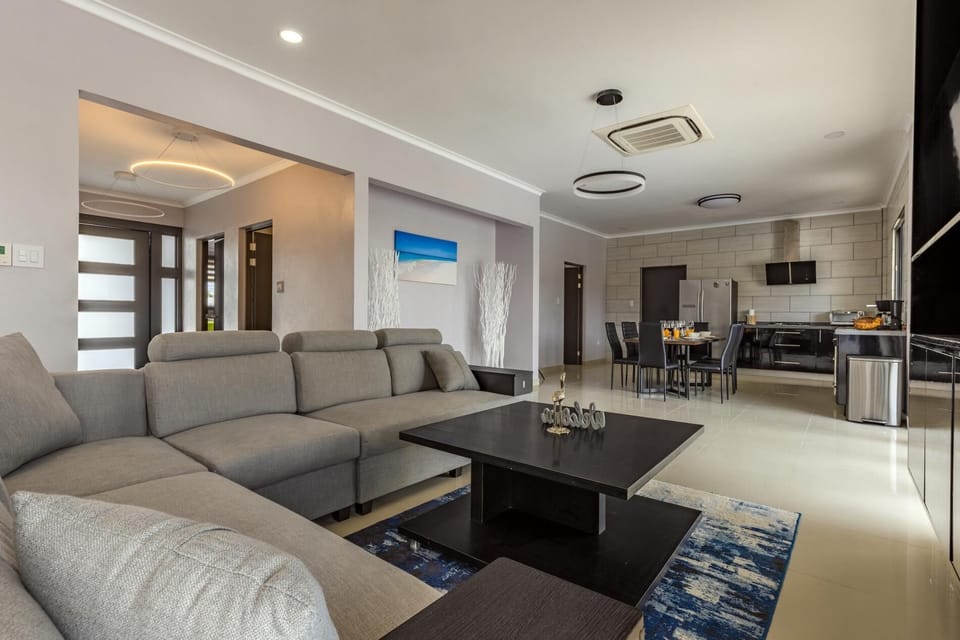 A classy living room with a large and comfy sofa.