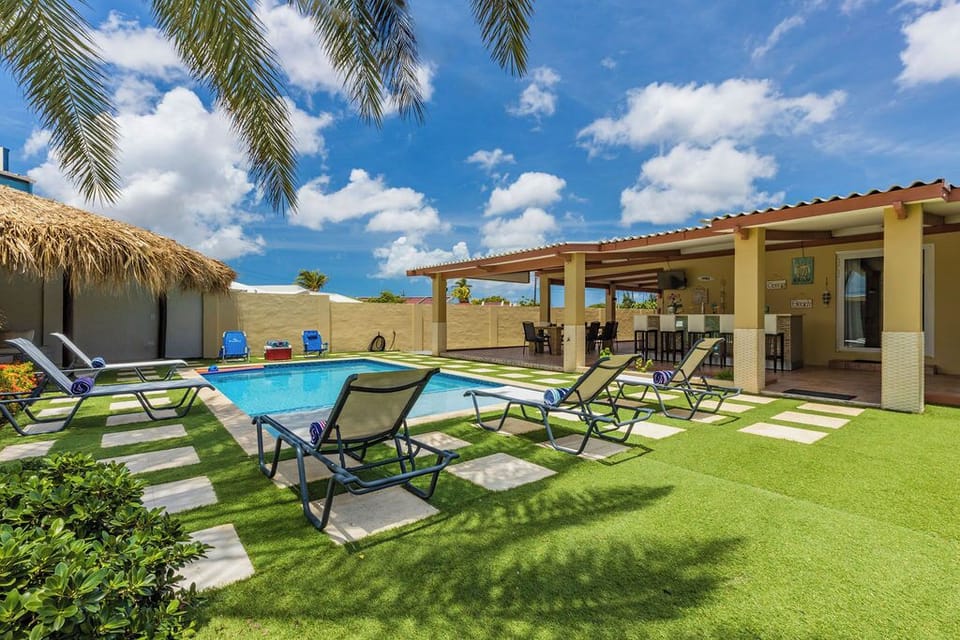The landscaping in the pool area is well-maintained.  There are lush plants and trees. More sunlounger and beach essentials are available. The outdoor pool will surely be a hit with youngsters.
