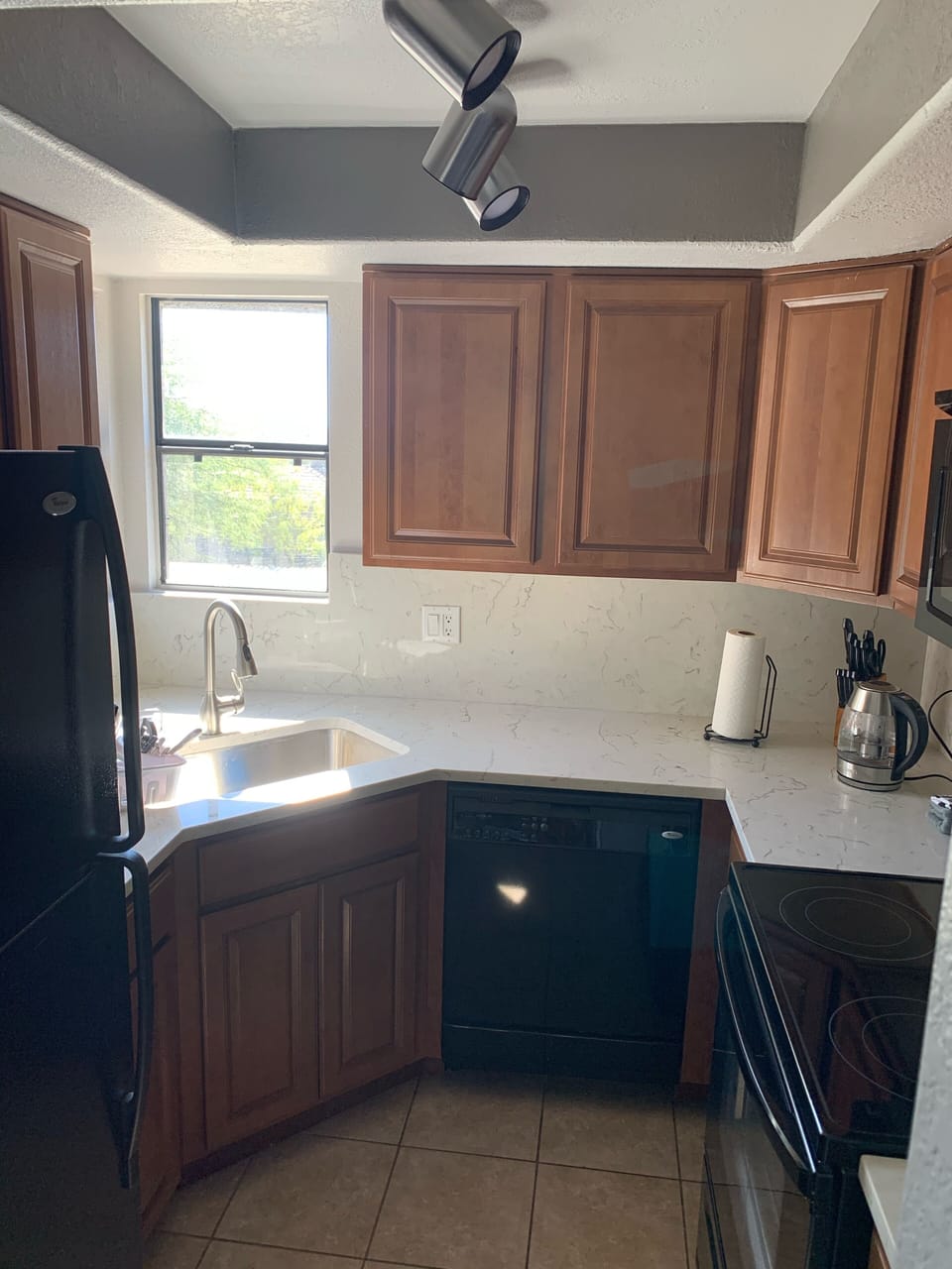 Totally renovated kitchen with tile flooring and quartz countertops & backsplash