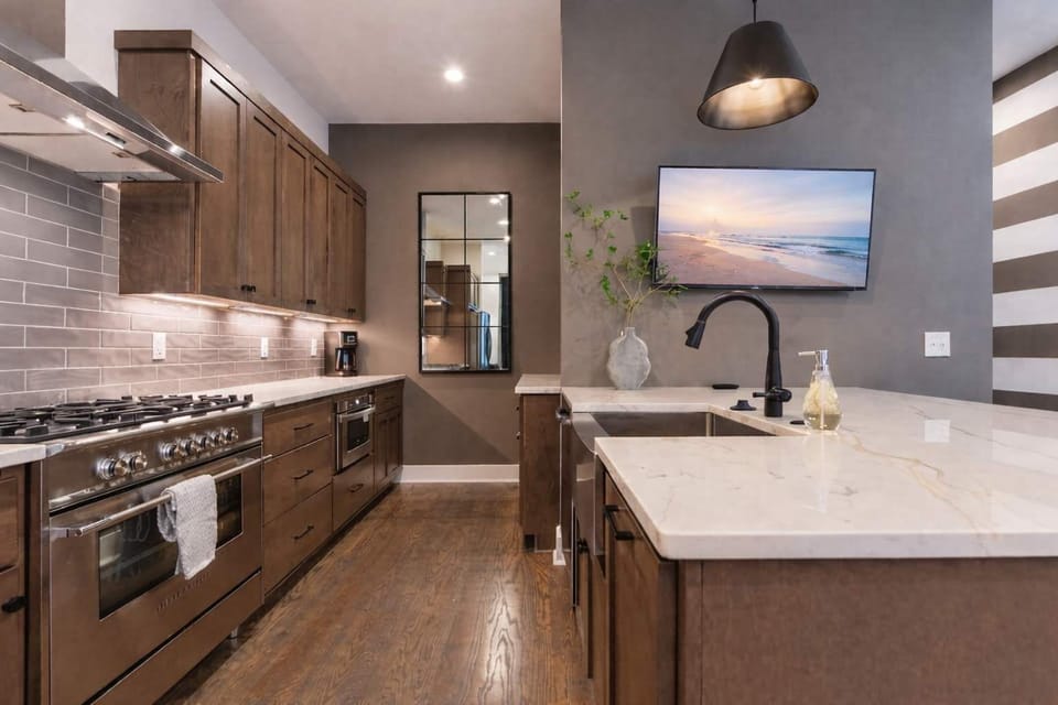 Cook and entertain in a modern, fully equipped kitchen with elegant wood finishes.