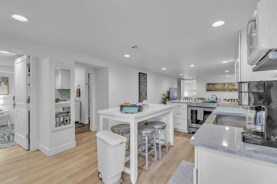 Bright modern kitchen with island seating and sleek stainless appliances