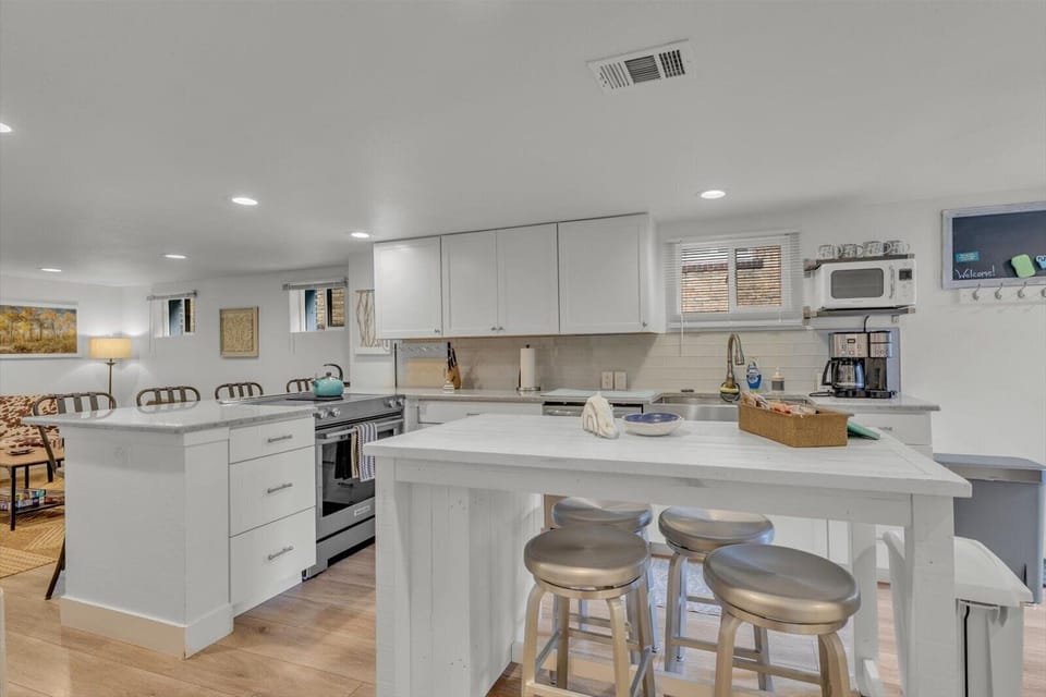 Bright open kitchen with large island, bar seating, and plenty of prep space