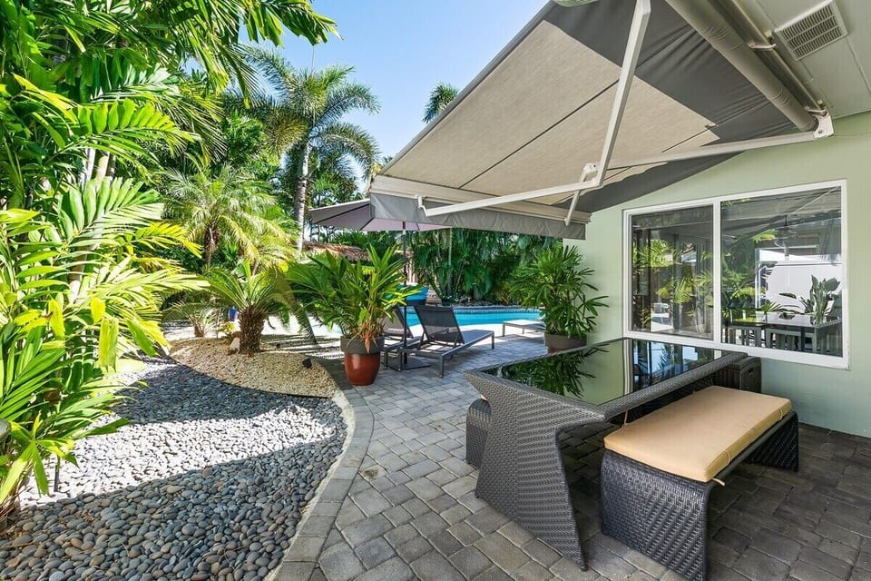 Relax in the private backyard with amazing day and nighttime views and amenities that include a heated pool, 6 person hot tub, outdoor shower, outdoor fire pit with lounge seating, umbrellas for shade, pool chaise lounge chairs, BBQ grill and comfortable dining seating under shade all surrounded by tropical landscaping.