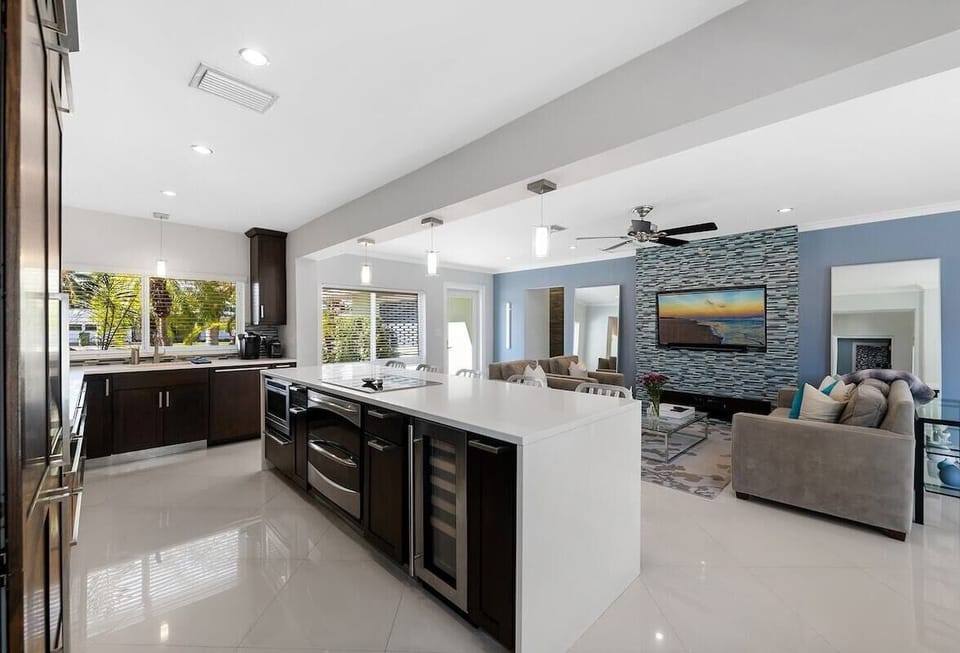 Prepare a family meal in the fully-equipped custom kitchen offering bar seating, updated appliances and pool views.