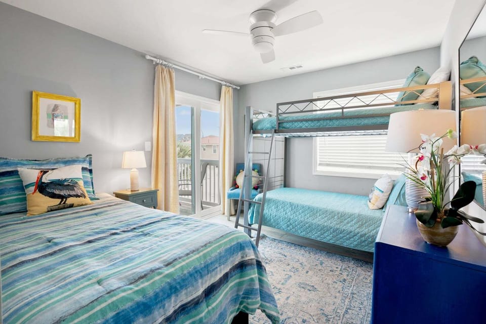 Bunk beds and a sliding door with an ocean view at Sea Lakes 103C, a 2-bedroom Cherry Grove rental