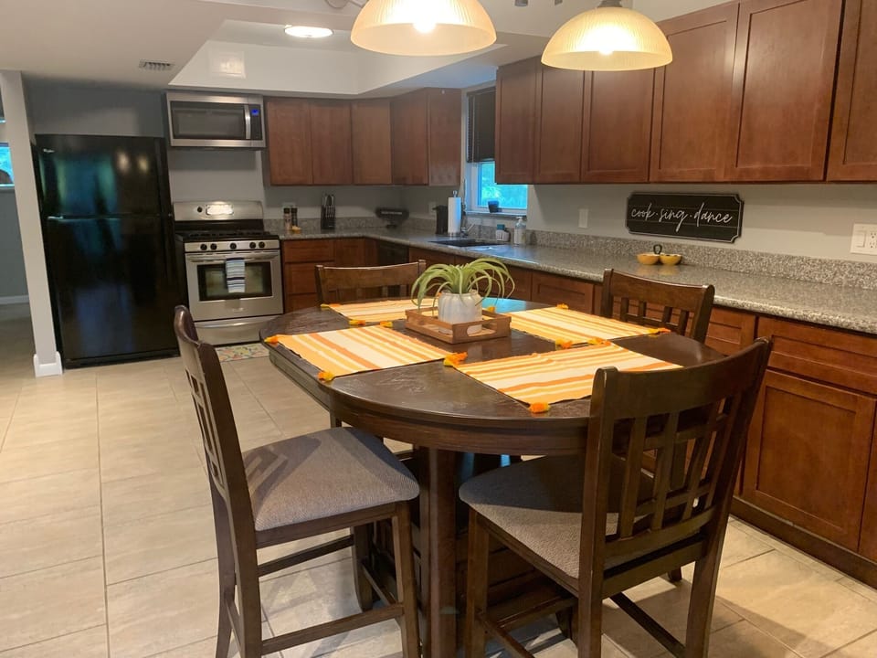 Large open kitchen with granite and  dining table for four. 
