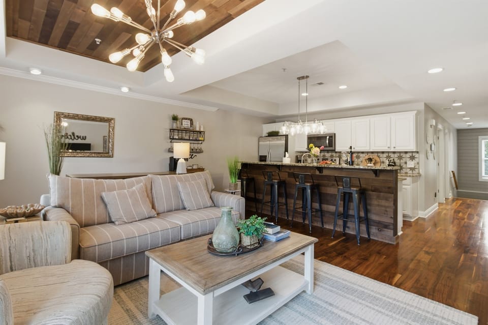 Spacious living area connected to a modern kitchen, perfect for gathering and relaxing.