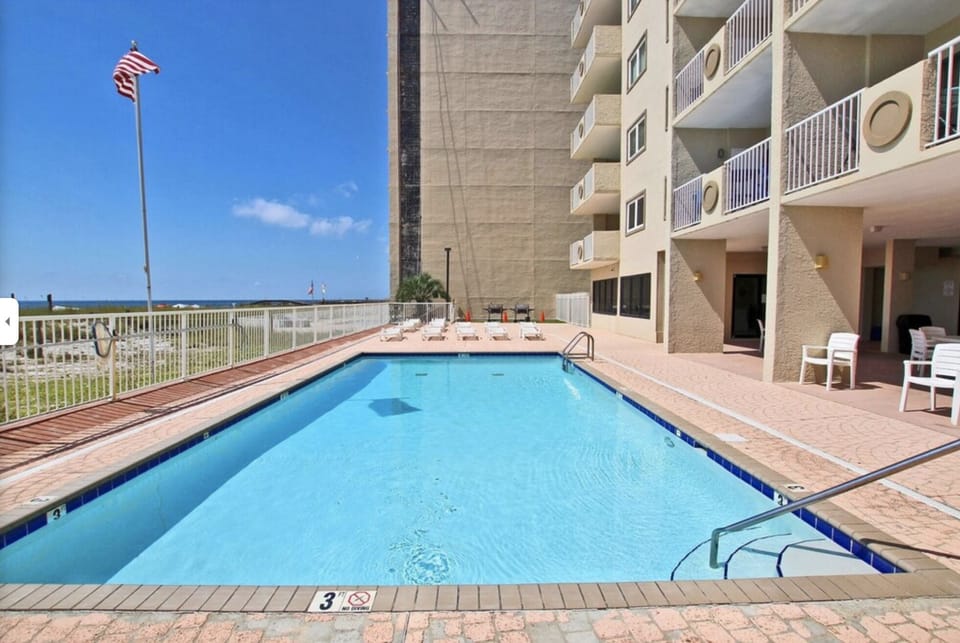 Outdoor Pool with plenty of chairs on all sides, less crowded than larger condos