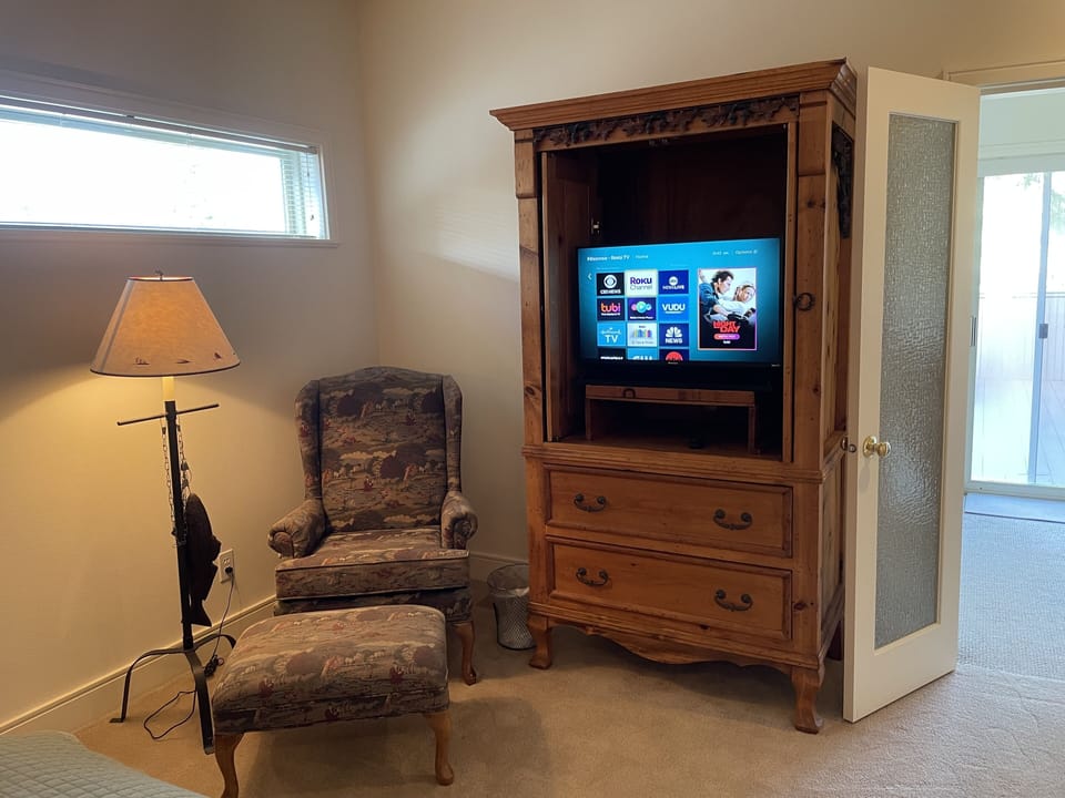 Seating area and 
TV located in the Main Floor Primary Suite Bedroom