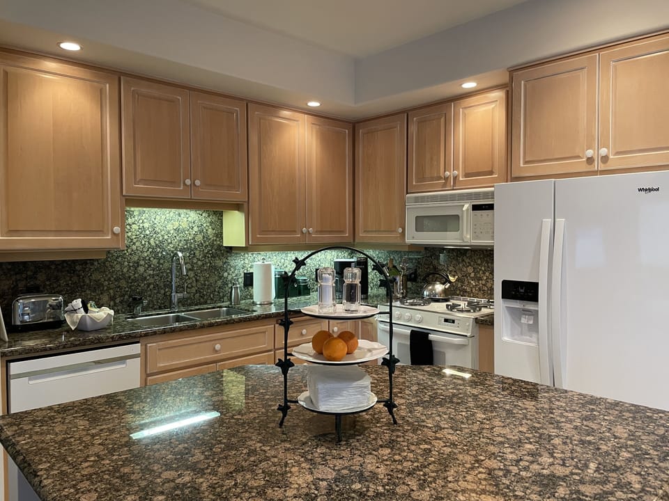 Fully Stocked kitchen with a gas range  and refrigerator w/door water & ice.