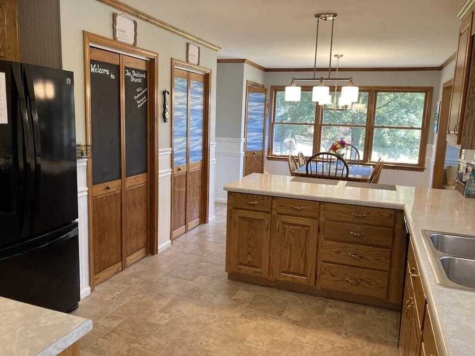 Large kitchen dining are with table for 6 and 3 stools at the bar