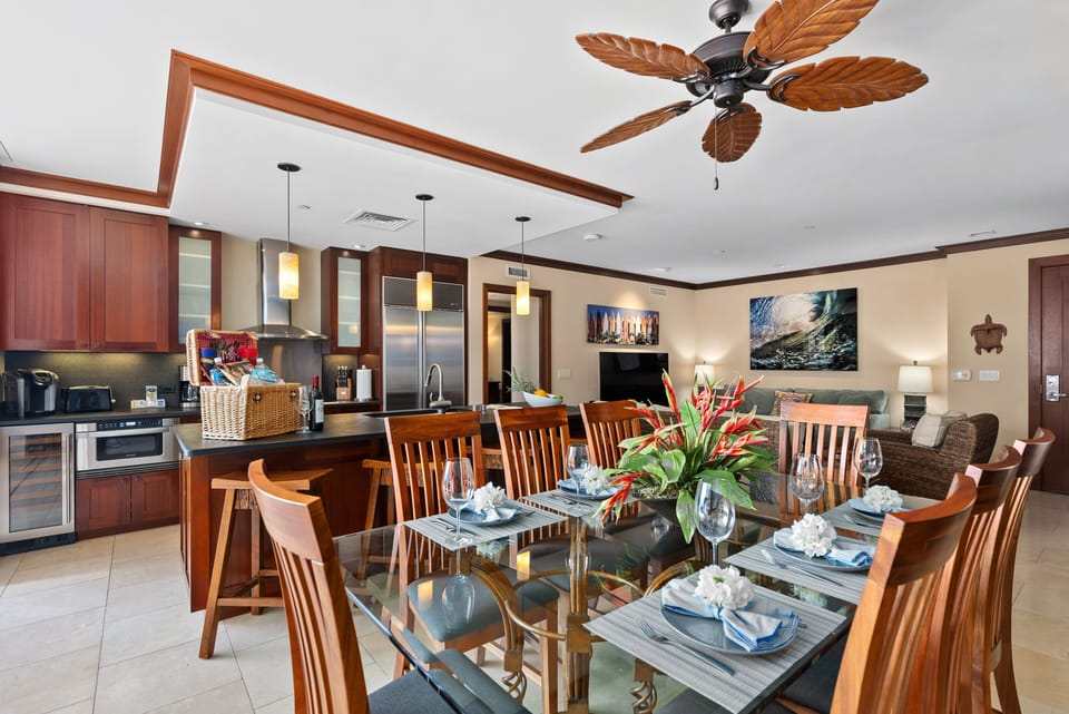 Dining area with eight-seat table and gourmet kitchen, and a large center island with four bar seats