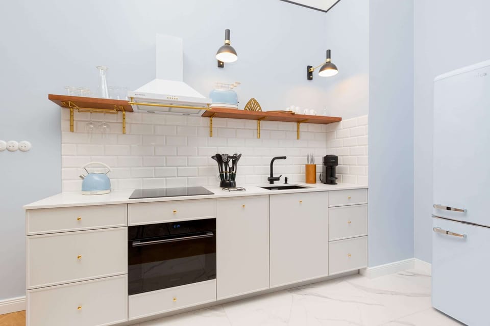 Fully equipped kitchenette with a kettle, fridge freezer, induction hob, dishwasher, toaster and coffee maker.