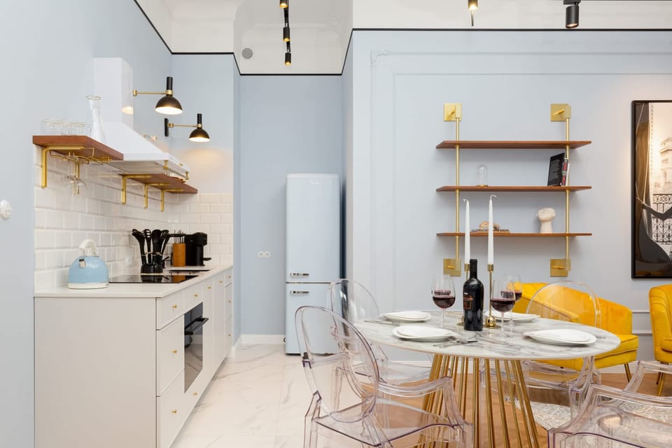 Fully equipped and chic kitchenette with an electric kettle, fridge freezer, induction hob, dishwasher, toaster, coffee maker and dining area.