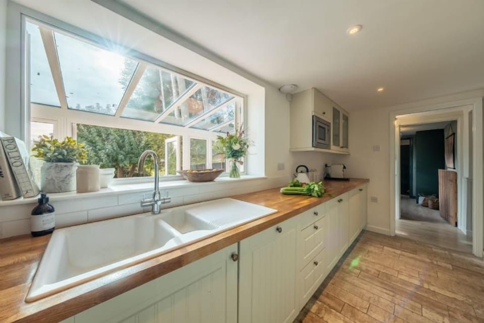 Ground floor: The kitchen has windows opening into the garden room ...