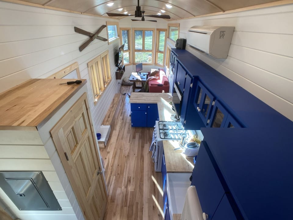 View from loft area down to kitchen and living area